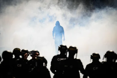 A protester walks amid the smoke of tear gas thrown by an anti-riot police officers during demonstration in Nantes, western France, on September 18, 2025, part of a day of nationwide strikes and protests called by unions over France's national budget. France is bracing for a day of nationwide protests on September 18, 2025, with a source close to the authorities saying some 800,000 people are expected to take to the streets. In a rare show of unity, trade unions have urged French people to strike in protest at the authorities' "horror show" draft budget designed to reduce France's ballooning debt. (Photo by Loic VENANCE / AFP)Editoria: POLLocal: NantesIndexador: LOIC VENANCESecao: social issues (general)Fonte: AFPFotógrafo: STF<!-- NICAID(16128787) -->