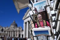 Postcards of Pope Leo XIV are on sale at a souvenirs shop near St Peter's square in the Vatican on October 12, 2026. Pope Leo XIV has said on October 11, 2026 he will have an operation to remove a lump on his lung this week, the first time a pope has made a personal medical announcement of this kind. (Photo by Tiziana FABI / AFP)<!-- NICAID(16385671) -->