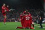 Liverpool's Dutch striker Cody Gakpo celebrates with teammates after scoring the opening goal of the English Premier League football match between Liverpool and Manchester United at Anfield in Liverpool, north west England on March 5, 2023. (Photo by Paul ELLIS / AFP) / RESTRICTED TO EDITORIAL USE. No use with unauthorized audio, video, data, fixture lists, club/league logos or 'live' services. Online in-match use limited to 120 images. An additional 40 images may be used in extra time. No video emulation. Social media in-match use limited to 120 images. An additional 40 images may be used in extra time. No use in betting publications, games or single club/league/player publications. / <!-- NICAID(15366945) -->