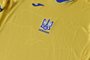 A picture taken on June 6, 2021 shows a EURO 2020 jersey of the Ukrainian national football team. - Ukraine provoked Moscow's ire on June 6, 2021 as its football federation unveiled Euro 2020 uniforms that feature Russian-annexed Crimea and nationalist slogans. The uniforms in the blue-and-yellow colours of the Ukrainian flag feature the silhouette of Ukraine that includes Russia-annexed Crimea and the separatist-controlled regions of Donetsk and Lugansk as well as the words "Glory to Ukraine! Glory to the Heroes!" (Photo by STRINGER / AFP)<!-- NICAID(14803717) -->