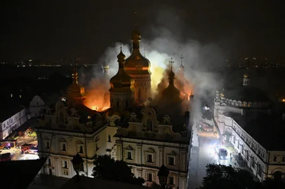 Smoke and fire rises from the Dormition Cathedral in the Orthodox complex of the Kyiv Pechersk Lavra following a Russian missile strike on the Ukrainian capital Kyiv on June 15, 2026, amid the Russian invasion in Ukraine. Russia fired a barrage of missiles at several major Ukrainian cities, setting Kyiv's historic Dormition Cathedral on fire and killing nine, while Ukraine strikes claimed three lives south of Moscow. (Photo by Genya SAVILOV / AFP)<!-- NICAID(16306341) -->