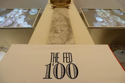 A sign and video screens in the exhibition "The Fed at 100" at the Museum of American Finance December 17, 2013 in New York. The exhibition marks the 100th anniversary of the Federal Reserve System.  The Fed was created on December 23, 1913, with the enactment of the Federal Reserve Act, largely in response to a series of financial panics, particularly a severe panic in 1907. Over time, the roles and responsibilities of the Federal Reserve System have expanded and its structure has evolved. Events such as the Great Depression were major factors leading to changes in the system.  AFP PHOTO/Stan HONDA