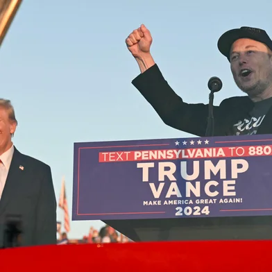 (FILES) Tesla CEO Elon Musk (R) speaks on stage as he joins former US President and Republican presidential candidate Donald Trump during a campaign rally at site of his first assassination attempt in Butler, Pennsylvania on October 5, 2024. Billionaire Elon Musk was expected in court in Philadelphia on October 31, 2024, after a judge ordered him to attend a hearing in a lawsuit seeking to halt his $1 million giveaways to registered US voters in swing states. (Photo by Jim WATSON / AFP)<!-- NICAID(15906489) -->