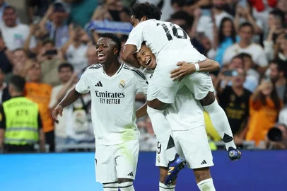FBL-ESP-LIGA-REAL MADRID-ESPANYOLReal Madrid's French forward #09 Kylian Mbappe (C) celebrates with Real Madrid's Brazilian forward #16 Endrick (TOP) and Real Madrid's Brazilian forward #07 Vinicius Junior after scoring his team's fourth goal from the penalty spot during the Spanish league football match between Real Madrid CF and RCD Espanyol at the Santiago Bernabeu stadium in Madrid, on September 21, 2024.