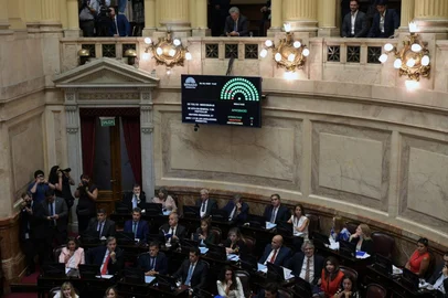 Argentina's Foreign Minister Pablo Quirno (C-Top) sits next to the board displaying the approved vote on the free trade agreement between the EU and Mercosur at the Argentine Congress on February 26, 2026. (Photo by Juan Mabromata / AFP)<!-- NICAID(16233713) -->