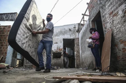 Remoção da última família na Vila Nazaré, para ampliação da pista do Aeroporto Internacional Salgado Filho. Na foto: Maria Aparecida da Silva Garcia (blusa rosa) e Luis Ronaldo Santos Cardoso (camisa cinza e calça jeans).Foto: André Ávila/ Agência RBSIndexador: Andre Avila<!-- NICAID(14832715) -->