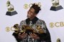 US singer Jon Batiste poses in the press room with his Grammys during the 64th Annual Grammy Awards at the MGM Grand Garden Arena in Las Vegas on April 3, 2022. - This year's leading Grammy nominee Jon Batiste soared past his heavyweight competition to win the coveted Album of the Year award for "We Are" (Photo by Patrick T. FALLON / AFP)<!-- NICAID(15059247) -->