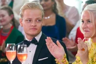 (FILES) This file photo taken on June 16, 2022 in Oslo, Norway, shows Marius Borg Høiby sitting next to his mother Norwegian Crown Princess Mette-Marit. Marius Borg Hoiby, the 28-year-old son of Norway's crown princess is suspected of 23 offences including three rapes, Norwegian police said on June 27, 2025 as they announced the closure of an investigation launched 10 months ago. Hoiby, who was born of a relationship before Crown Princess Mette-Marit's marriage to Crown Prince Haakon, has been under investigation since his arrest on August 4, 2024 suspected of assaulting his girlfriend, after which a slew of allegations emerged against him.