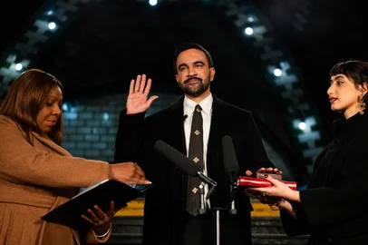 New York mayor-elect Zohran Mamdani (C) places his hand on a Quran as he is sworn in by New York Attorney General Letitia James (L) and his wife Rama Duwaji looks on in New York, on January 1, 2026. New York mayor-elect Zohran Mamdani is set to become the US city's first Muslim mayor, and the youthful optimism of his Democratic Socialist platform will be put to the test as he takes office on January 1, 2026, with high expectations. (Photo by Amir Hamja / POOL / AFP)<!-- NICAID(16196376) -->