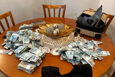 Reprodução / Polícia Federal Pessoa que estava em apartamento alvo de busca e apreensão em Balneário Camboriú, Santa Catarina, chegou a arremessar uma mala cheia de dinheiro pela janela.<!-- NICAID(16223085) -->