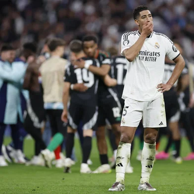 Real Madrid's English midfielder #05 Jude Bellingham reacts at the end of the UEFA Champions League quarter final second leg football match between Real Madrid CF and Arsenal at Santiago Bernabeu Stadium in Madrid on April 16, 2025. (Photo by OSCAR DEL POZO / AFP)<!-- NICAID(16018522) -->