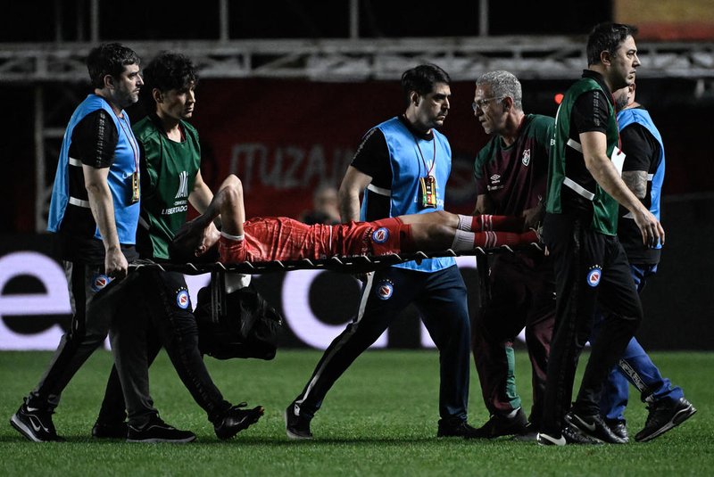 Argentinos Juniors' defender Luciano Sanchez is carried out on a stretcher after being injured during the Copa Libertadores round of 16 first leg football match between Argentina's Argentinos Juniors and Brazil's Fluminense at the Diego Armando Maradona stadium in Buenos Aires, on August 1, 2023. (Photo by Luis ROBAYO / AFP)<!-- NICAID(15499068) -->