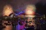 The "family fireworks", displayed three hours before midnight every year ahead of the main show at midnight, fill the sky over the Opera House (L) and Sydney Harbour Bridge (R) in Sydney on New Year's Eve on December 31, 2023. (Photo by Izhar KHAN / AFP)Editoria: LIFLocal: SydneyIndexador: IZHAR KHANSecao: public holidayFonte: AFPFotógrafo: STR<!-- NICAID(15638117) -->