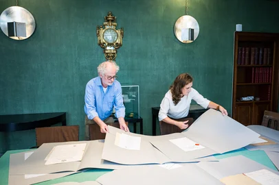 Executive Director of the Nobel Foundation Hanna Stjarne (R) and curator Ulf Larsson look at Alfred Nobels patents in Stockholm on September 2, 2025. A dozen patents belonging to Swedish inventor and philanthropist Alfred Nobel and lost for almost 50 years were recently found in a Swedish couple's summer house, the Nobel Foundation told AFP. (Photo by Jonathan NACKSTRAND / AFP)<!-- NICAID(16118301) -->