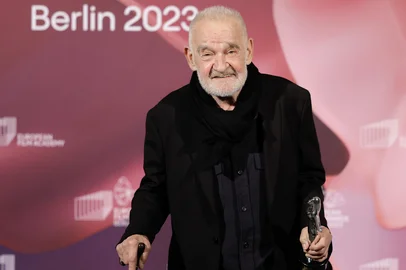 (FILES) Hungarian film director and screenwriter Bela Tarr poses with his honorary award trophy during the 36th European Film Awards ceremony in Berlin, on December 9, 2023. Legendary Hungarian filmmaker Bela Tarr died on January 6, 2026 at the age of 70, director Bence Fliegauf informed national news agency MTI on behalf of the family. Tarr was best known for the best known for directing the movie "Satantango" (1994), a seven-hour epic about the collapse of communism in Eastern Europe and its material and spiritual decline, adapted from the novel by Nobel laureate Laszlo Krasznahorkai, whom he frequently collaborated with. (Photo by Odd ANDERSEN / AFP)<!-- NICAID(16198687) -->