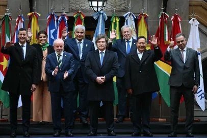 (L to R back) Ecuador's Vice President Maria Jose Pinto, Panama's President Jose Raul Mulino, and Chile's Foreign Minister Alberto van Klaveren; (L to R front) Paraguay's President Santiago Pena, Brazil's President Luiz Inacio Lula da Silva, Argentina's President Javier Milei, Bolivia's President Luis Arce Catacora, and Uruguay's President Yamandu Orsi, pose for the family photo during the 66th Summit of Leaders of Mercosur and Associated States at the San Martin Palace in Buenos Aires on July 3, 2025. The fate of a landmark trade deal with the European Union, which France is trying to block, loomed over a gathering of South America's Mercosur bloc gathering. Brussels in December struck a deal with Mercosur's founding members to create a free trade zone of around 700 million consumers, though it still needs to be ratified by EU member states.