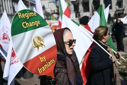 People hold hold signs during a demonstration in support of the Iranian people and to demand the end of the Islamic Republic of Iran in Washington, DC, on March 1, 2026. The United States and Israel launched waves of strikes February 28 against targets in Iran, sparking swift retaliation by the Islamic republic. (Photo by Brendan SMIALOWSKI / AFP)<!-- NICAID(16237796) -->