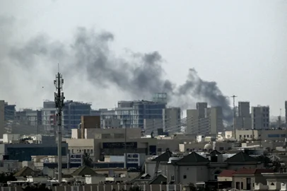 A plume of smoke rises over buildings in Doha on March 5, 2026. Multiple rounds of explosions echoed over Doha on March 5 just hours after officials said they were evacuating residents living near the US embassy. Gulf countries have been targeted by repeated waves of Iranian drone and missile attacks in retaliation for the massive US-Israeli air campaign. (Photo by Mahmud Hams / AFP)<!-- NICAID(16238966) -->