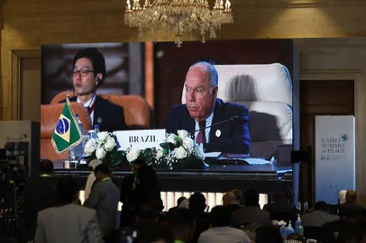 Journalists watch a large screen showing the Brazilian Foreign Minister Mauro Vieira addressing the International Peace Summit hosted by the Egyptian president in Cairo on October 21, 2023, amid the ongoing battles between Israel and the Palestinian group Hamas. Thousands of people, both Israeli and Palestinians have died since October 7, 2023, after Palestinian Hamas militants based in the Gaza Strip, entered southern Israel in a surprise attack leading Israel to declare war on Hamas in Gaza on October 8. (Photo by Khaled DESOUKI / AFP)<!-- NICAID(15575539) -->