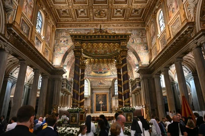 (FILES) A picture shows the interior of the Saint Mary Major basilica during the vespers to mark the anniversary of the Dedication of the Papal Basilica Santa Maria Maggiore on August 5, 2024 in Rome. The Holy Door will be reopened during the Holy Year of 2025. Pope Francis, an energetic reformer who inspired widespread devotion from Catholics but riled traditionalists, died on April 21, 2025 aged 88. Francis's desire to chart a different path was evident right to the end, with his decision to be buried not in St Peter's Basilica but in Rome's Santa Maria Maggiore basilica. (Photo by Alberto PIZZOLI / AFP)<!-- NICAID(16020841) -->