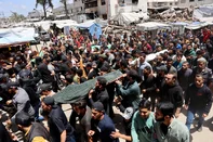 EDITORS NOTE: Graphic content / Palestinian mourners carry the bodies of Ezzedine Al-Haddad, the slain chief of the Qassam Brigades -- the armed wing of Palestinian movement Hamas, his wife and daughter, all killed in an overnight Israeli strike, during their funeral in Gaza City on May 16, 2026. Israel said on May 15 that it carried out a strike in Gaza targeting Haddad. Since Hamas's October 7, 2023 attack on Israel, the Israeli military and intelligence services have waged an extensive campaign targeting the group's senior political leaders and militant commanders in Gaza and across the region. (Photo by Omar AL-QATTAA / AFP)<!-- NICAID(16286886) -->