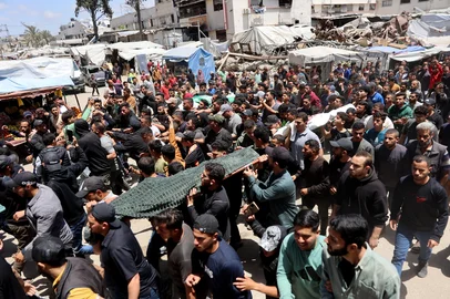 OMAR AL-QATTAA / AFP EDITORS NOTE: Graphic content / Palestinian mourners carry the bodies of Ezzedine Al-Haddad, the slain chief of the Qassam Brigades -- the armed wing of Palestinian movement Hamas, his wife and daughter, all killed in an overnight Israeli strike, during their funeral in Gaza City on May 16, 2026. Israel said on May 15 that it carried out a strike in Gaza targeting Haddad. Since Hamas's October 7, 2023 attack on Israel, the Israeli military and intelligence services have waged an extensive campaign targeting the group's senior political leaders and militant commanders in Gaza and across the region. (Photo by Omar AL-QATTAA / AFP)<!-- NICAID(16286886) -->