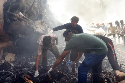 Rescue officials work at the site where Air India flight 171 crashed in a residential area near the airport in Ahmedabad on June 12, 2025. The London-bound enger plane crashed on June 12 in India's western city of Ahmedabad with 242 on board, aviation officials said in what the airline called a "tragic accident". (Photo by Sam PANTHAKY / AFP)<!-- NICAID(16057931) -->