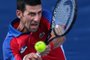 Serbia's Novak Djokovic returns a shot to Bolivia's Hugo Dellien during their Tokyo 2020 Olympic Games men's singles first round tennis match at the Ariake Tennis Park in Tokyo on July 24, 2021. (Photo by Giuseppe CACACE / AFP)Editoria: SPOLocal: TokyoIndexador: GIUSEPPE CACACESecao: sports eventFonte: AFPFotógrafo: STF<!-- NICAID(14846885) -->