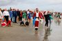 A surfer dressed as Santa poses during the 15th annual Surfing Santas event in Cocoa Beach, Florida, on December 24, 2023. (Photo by Eva Marie UZCATEGUI / AFP)<!-- NICAID(15633743) -->