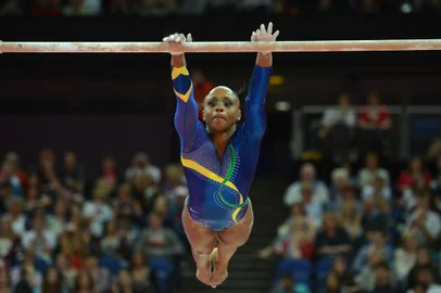 Brazil's gymnast Daiane Dos Santos performs on the uneven bars during the women's qualification of the artistic gymnastics event of the London Olympic Games on July 29, 2012 at the 02 North Greenwich Arena in London. AFP PHOTO / BEN STANSALL<!-- NICAID(8457228) -->