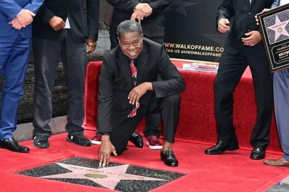 Brazilian percussionist Paulinho da Costa poses on his star during his Walk of Fame ceremony in Hollywood, California on May 13, 2026. (Photo by Frederic J. Brown / AFP)<!-- NICAID(16284742) -->