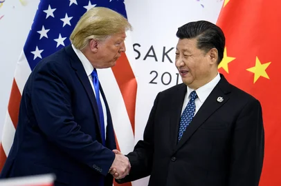 (FILES) In this file China's President Xi Jinping (R) shakes hands with US President Donald Trump before a bilateral meeting on the sidelines of the G20 Summit in Osaka on June 29, 2019. - The United States was poised Thursday to announce a historic trade deal with China, days before new tariffs are due to kick in between the world's two largest economies, easing a commercial dispute that has roiled markets for almost two years. (Photo by Brendan Smialowski / AFP)<!-- NICAID(14358479) -->