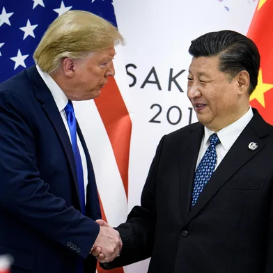 (FILES) In this file China's President Xi Jinping (R) shakes hands with US President Donald Trump before a bilateral meeting on the sidelines of the G20 Summit in Osaka on June 29, 2019. - The United States was poised Thursday to announce a historic trade deal with China, days before new tariffs are due to kick in between the world's two largest economies, easing a commercial dispute that has roiled markets for almost two years. (Photo by Brendan Smialowski / AFP)<!-- NICAID(14358479) -->