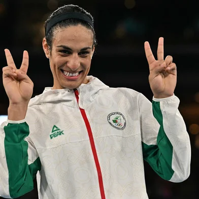 Gold medallist Algeria's Imane Khelif poses on the podium during the medal ceremony for the women's 66kg final boxing category during the Paris 2024 Olympic Games at the Roland-Garros Stadium, in Paris on August 9, 2024. (Photo by MOHD RASFAN / AFP)<!-- NICAID(15837411) -->