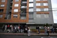 People remain on the street after an earthquake in Bogota on June 8, 2025. A powerful, shallow 6.3-magnitude earthquake shook the Colombian capital of Bogota early Saturday, according to AFP reporters on the ground and the United States Geological Survey. Buildings shook, sirens blared around the capital and people rushed out onto the streets. (Photo by Raul ARBOLEDA / AFP)<!-- NICAID(16054994) -->