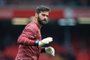 Liverpool's Brazilian goalkeeper Alisson Becker warms up ahead of the English Premier League football match between Liverpool and Burnley at Anfield in Liverpool, north west England on August 21, 2021. (Photo by Lindsey Parnaby / AFP) / RESTRICTED TO EDITORIAL USE. No use with unauthorized audio, video, data, fixture lists, club/league logos or 'live' services. Online in-match use limited to 120 images. An additional 40 images may be used in extra time. No video emulation. Social media in-match use limited to 120 images. An additional 40 images may be used in extra time. No use in betting publications, games or single club/league/player publications. / Editoria: SPOLocal: LiverpoolIndexador: LINDSEY PARNABYSecao: soccerFonte: AFPFotógrafo: STR<!-- NICAID(14872239) -->