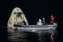 This handout image courtesy of NASA and made available on May 2, 2021, shows the support teams working around the SpaceX Crew Dragon Resilience spacecraft shortly after it landed with NASA astronauts Mike Hopkins, Shannon Walker, and Victor Glover, and Japan Aerospace Exploration Agency (JAXA) astronaut Soichi Noguchi aboard in the Gulf of Mexico off the coast of Panama City, Florida on May 2, 2021. - NASAs SpaceX Crew-1 mission was the first crew rotation flight of the SpaceX Crew Dragon spacecraft and Falcon 9 rocket with astronauts to the International Space Station as part of the agencys Commercial Crew Program. (Photo by Bill INGALLS / (NASA/Bill Ingalls) / AFP) / RESTRICTED TO EDITORIAL USE - MANDATORY CREDIT "AFP PHOTO /NASA/Bill INGALLS" - NO MARKETING - NO ADVERTISING CAMPAIGNS - DISTRIBUTED AS A SERVICE TO CLIENTS<!-- NICAID(14771816) -->