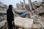 A man stands next to the rubble of a building following an earthquake in the town of Sarmada in the countryside of the northwestern Syrian Idlib province, early on February 6, 2023. - A 7.8-magnitude earthquake hit Turkey and Syria on February 6, killing hundreds of people as they slept, levelling buildings, and sending tremors that were felt as far away as the island of Cyprus and Egypt. (Photo by Mohammed AL-RIFAI / AFP) / The erroneous mention[s] appearing in the metadata of this photo by Mohammed AL-RIFAI has been modified in AFP systems in the following manner: [the town Sarmada] instead of [Zardana]. Please immediately remove the erroneous mention[s] from all your online services and delete it (them) from your servers. If you have been authorized by AFP to distribute it (them) to third parties, please ensure that the same actions are carried out by them. Failure to promptly comply with these instructions will entail liability on your part for any continued or post notification usage. Therefore we thank you very much for all your attention and prompt action. We are sorry for the inconvenience this notification may cause and remain at your disposal for any further information you may require.<!-- NICAID(15340977) -->