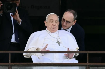 Pope Francis appears at a window of the Gemelli hospital before to be discharge after a five weeks hospitalization for pneumonia, in Rome on March 23, 2025. Pope Francis is to leave hospital todayand return to his residence in the Vatican, where he is to spend "at least two months" recovering, one of his doctors announced during a press conference on March 22, 2025. (Photo by Filippo MONTEFORTE / AFP)<!-- NICAID(16001466) -->