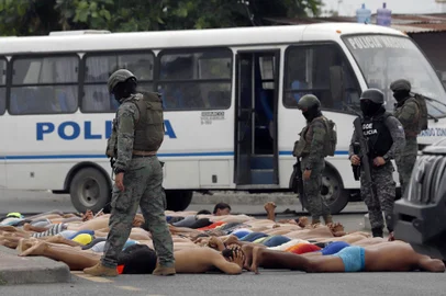 Police keep watch over arrested men who attempted to take over a hospital in Guayas, Ecuador, on January 21, 2024. Police in violence-plagued Ecuador arrested 68 people Sunday who had attempted to take over a hospital in the country's southwest in the midst of a "war" between drug gangs and the security forces. (Photo by STRINGER / AFP) / The erroneous mention[s] appearing in the metadata of this photo has been modified in AFP systems in the following manner: [2024] instead of [2023]. Please immediately remove the erroneous mention[s] from all your online services and delete it (them) from your servers. If you have been authorized by AFP to distribute it (them) to third parties, please ensure that the same actions are carried out by them. Failure to promptly comply with these instructions will entail liability on your part for any continued or post notification usage. Therefore we thank you very much for all your attention and prompt action. We are sorry for the inconvenience this notification may cause and remain at your disposal for any further information you may require.<!-- NICAID(15656742) -->