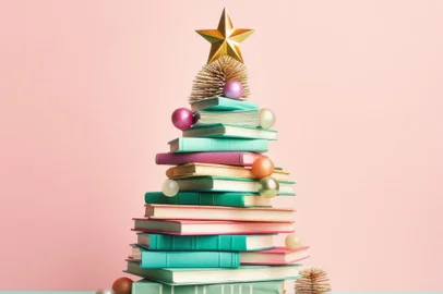 On a crisp winter morning, a festive stack of books with a golden star on top stands proudly against a vibrant pastel christmas tree, bringing a sense of joy and hope for the new yearFonte: 647176919<!-- NICAID(15623267) -->