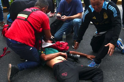 Argentinean photojournalist Pablo Grillo receives medical treatment by paramedics after being injured during a protest of pensioners supported by football fans against the government of President Javier Milei in Buenos Aires on March 12, 2025. (Photo by Nicolas SUAREZ / AFP)<!-- NICAID(15994865) -->