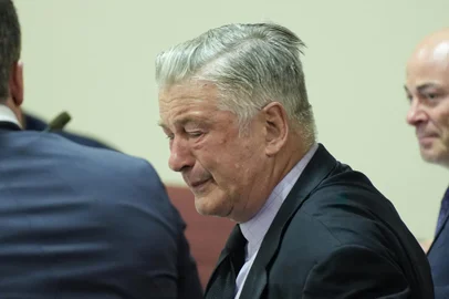 US actor Alec Baldwin reacts as he sits between his attorneys Alex Spiro (L) and Luke Nikas (R) at the conclusion of his trial on involuntary manslaughter at Santa Fe County District Court in Santa Fe, New Mexico, on July 12, 2024. Baldwin's trial for involuntary manslaughter was dismissed by a judge Friday after she ruled that key evidence over a fatal shooting on the set of "Rust" had been withheld from the defense. (Photo by RAMSAY DE GIVE / POOL / AFP)<!-- NICAID(15813470) -->
