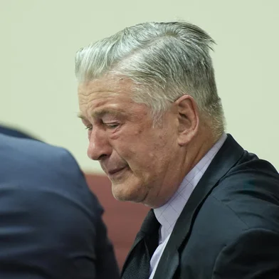 US actor Alec Baldwin reacts as he sits between his attorneys Alex Spiro (L) and Luke Nikas (R) at the conclusion of his trial on involuntary manslaughter at Santa Fe County District Court in Santa Fe, New Mexico, on July 12, 2024. Baldwin's trial for involuntary manslaughter was dismissed by a judge Friday after she ruled that key evidence over a fatal shooting on the set of "Rust" had been withheld from the defense. (Photo by RAMSAY DE GIVE / POOL / AFP)<!-- NICAID(15813470) -->