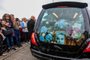 A photograph taken on August 8, 2023 shows the coffin and a picture of late Irish singer Sinead O'Connor, in the hearse during her funeral procession outside her former home in Bray, eastern Ireland, ahead of her funeral on August 8, 2023. A funeral service for Sinead O'Connor, the outspoken singer who rose to international fame in the 1990s, is to be held on Tuesday in the Irish seaside town of Bray. (Photo by PAUL FAITH / AFP)<!-- NICAID(15504155) -->