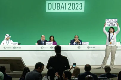 This image grab taken from AFPTV video footage shows an activist protesting on stage against fossil fuels during an event at the United Nations Climate Conference (COP28) in Dubai on December 11, 2023. A new draft climate agreement proposed on December 11 by the Emirati presidency of UN COP28 talks called for reducing the production and consumption of fossil fuels but it no longer mentioned a "phase-out". (Photo by AFPTV / AFP)Editoria: ENVLocal: DubaiIndexador: -Secao: diplomacyFonte: AFPTVFotógrafo: STR<!-- NICAID(15622579) -->