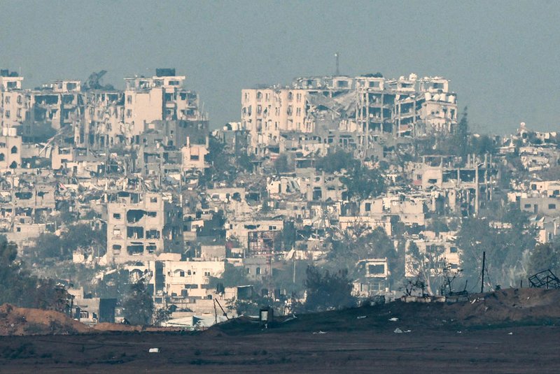 A picture taken from southern Israel near the border with the Gaza Strip on December 6, 2023, shows destroyed  buildings in Gaza amid continuing battles between Israel and the militant group Hamas. Israeli forces were encircling southern Gaza's main city on Wednesday, battling Hamas militants through streets and buildings in some of the most intense combat of the two-month war. (Photo by JACK GUEZ / AFP)Editoria: WARLocal: Israel-Gaza BorderIndexador: JACK GUEZSecao: warFonte: AFPFotógrafo: STF<!-- NICAID(15617705) -->