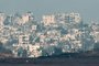 A picture taken from southern Israel near the border with the Gaza Strip on December 6, 2023, shows destroyed  buildings in Gaza amid continuing battles between Israel and the militant group Hamas. Israeli forces were encircling southern Gaza's main city on Wednesday, battling Hamas militants through streets and buildings in some of the most intense combat of the two-month war. (Photo by JACK GUEZ / AFP)Editoria: WARLocal: Israel-Gaza BorderIndexador: JACK GUEZSecao: warFonte: AFPFotógrafo: STF<!-- NICAID(15617705) -->