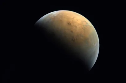 A handout picture provided on February 14, 2021 by the United Arab Emirates Space Agency (UAESA) taken by the Emirates eXploration Imager (EXI) after Mars Orbit Insertion (MOI) on board the First Emirates Mars Mission (EMM) from an altitude of 24,700 km above the Martian surface shows the Olympus Mons, the highest volcano on Mars, and the Tharsis Montes, three volcanoes named (top to bottom) Ascraeus Mons, Pavonis Mons and Arsia Mons. (Photo by - / United Arab Emirates Space Agency / AFP)<!-- NICAID(14714559) -->