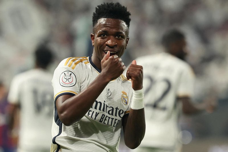 Real Madrid's Brazilian forward #07 Vinicius Junior celebrates after scoring his team's first goal during the Spanish Super Cup final football match between Real Madrid and Barcelona at the Al-Awwal Park Stadium in Riyadh, on January 14, 2024. (Photo by Giuseppe CACACE / AFP)<!-- NICAID(15650205) -->